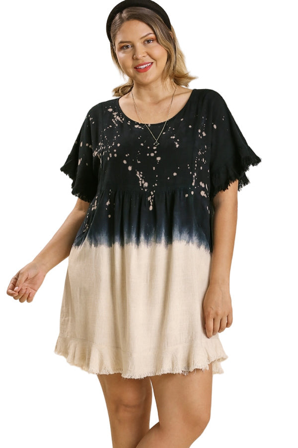 Woman wearing a black and white tie-dye dress with 'Plus Size' text above.