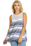 Woman wearing a sleeveless, striped dress with a white and blue pattern on a beige background.