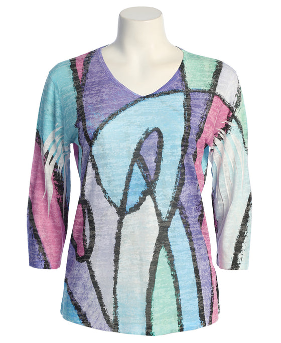 Colorful abstract patterned top on a mannequin against a white background