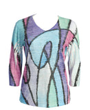 Colorful abstract patterned top on a mannequin against a white background