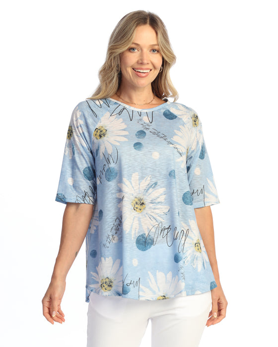 Woman wearing a blue floral print top on a white background