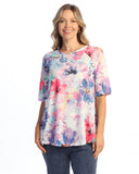 Woman wearing a colorful floral blouse on a white background