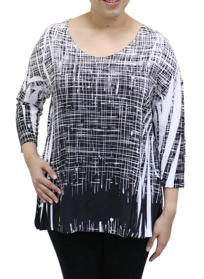 Black and white patterned top worn by a person on a white background