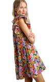 Woman wearing a colorful floral dress on a black background