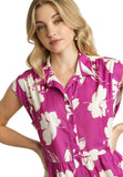 Woman wearing a raspberry mix floral dress against a white background
