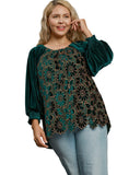 Woman wearing a green floral blouse with blue jeans on a white background