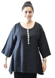 Woman wearing a black tunic with button details on a white background