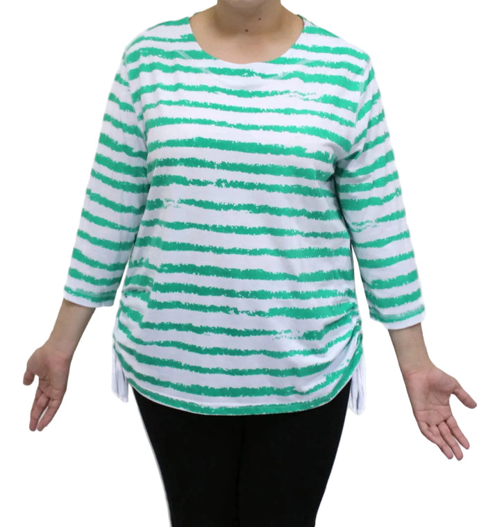 Green and white striped shirt worn by a person on a white background