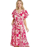Woman wearing a pink and white floral dress on a plain background