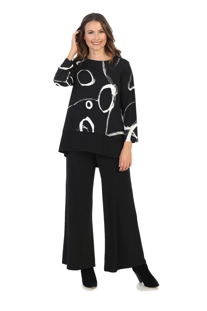 Woman wearing a black outfit with abstract white patterns on a white background