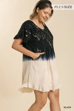 Woman wearing a black and white dress with a gradient effect on a beige background