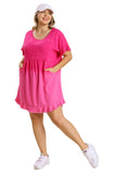 Woman wearing a hot pink dress with a beige background